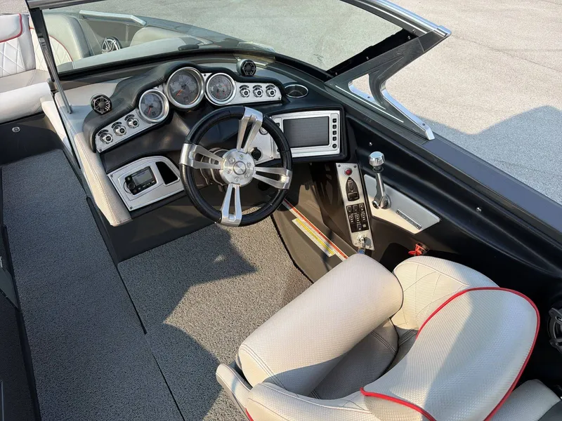 Slide: The Image of The image shows the cockpit of a 2015 MasterCraft X30 with a modern dashboard and sleek steering wheel. - 27
