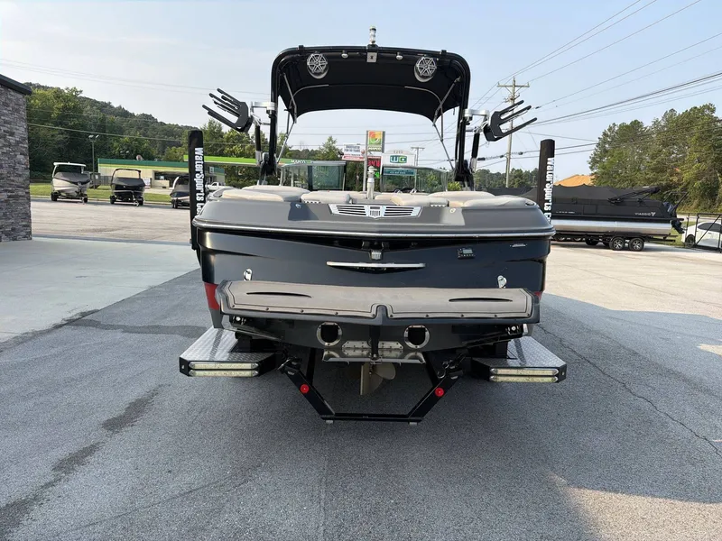 Slide: The Image of The image shows the rear of a 2015 MasterCraft X30 boat in a parking area. - 20