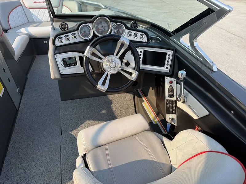 Slide: The Image of The image shows the cockpit of a 2015 MasterCraft X30 with a modern dashboard and sleek steering wheel. - 18
