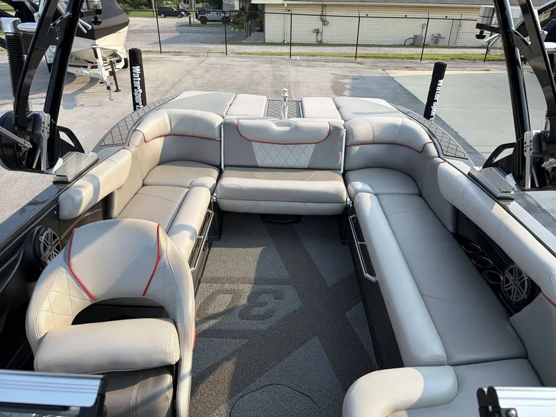 Slide: The Image of The image shows the interior of a 2015 MasterCraft X30 boat with gray upholstery. - 30