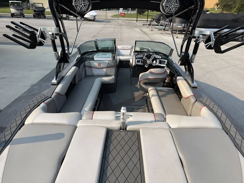 Slide: The Image of The image shows the interior of a 2015 MasterCraft X30 boat with gray and beige seating. - 12