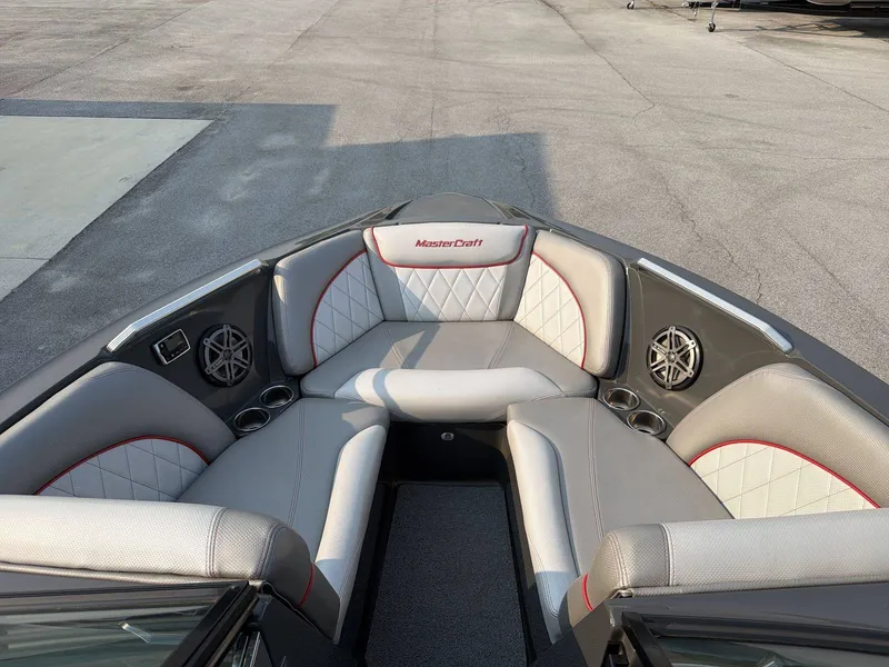 Slide: The Image of The image shows the bow of a 2015 MasterCraft X30 boat with gray and white upholstery. - 22