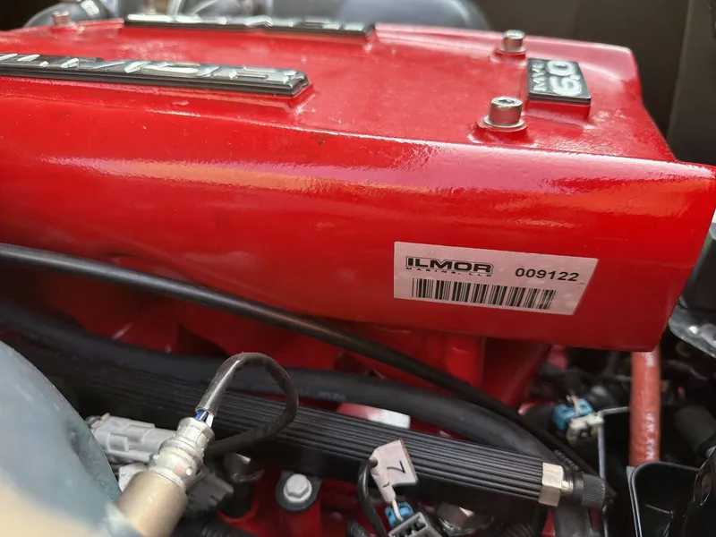 Slide: The Image of Close-up of a red Ilmor engine with visible cables and hoses. - 15