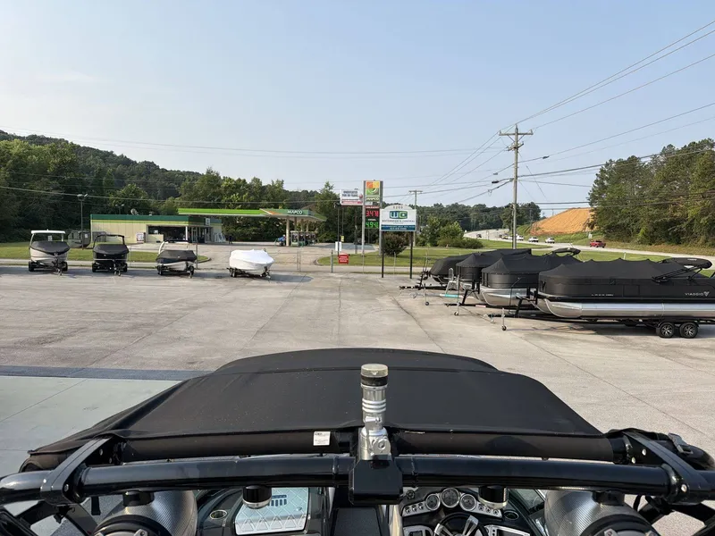 Slide: The Image of A 2015 MasterCraft X30 is parked among several other boats in a lot. - 8