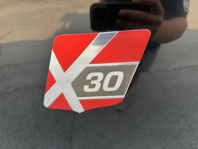 Slide: The Image of Close-up of the MasterCraft X30 logo on a boat. - 23