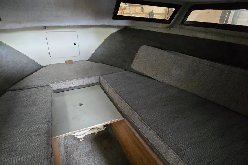 Slide: The Image of Interior cabin of a 1989 SportCraft 270 Fisherman boat with cushioned seating. - 18