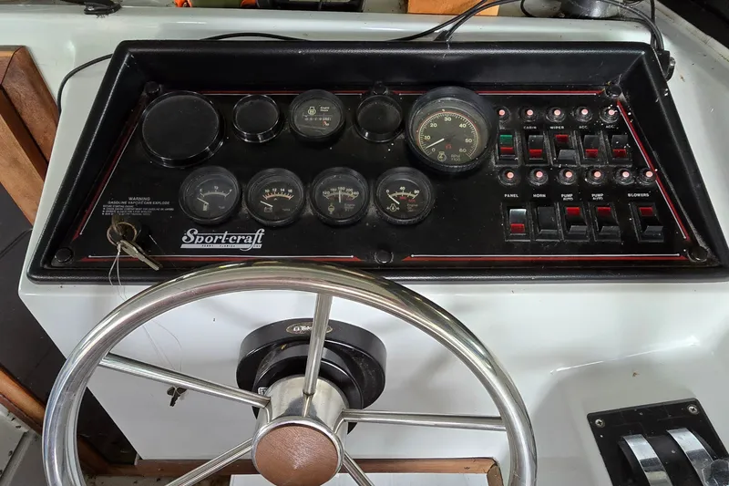 Slide: The Image of Control panel of a 1989 SportCraft 270 Fisherman boat with gauges and switches. - 13