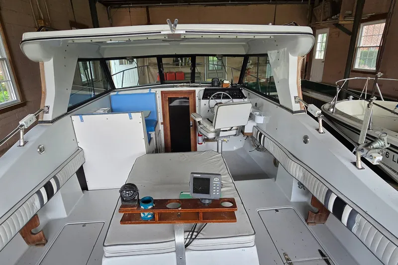 Slide: The Image of 1989 SportCraft 270 Fisherman boat interior with seating, steering wheel, and navigation equipment. - 7