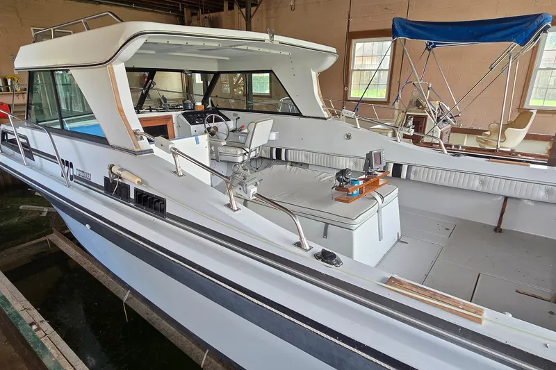 Slide: The Image of 1989 SportCraft 270 Fisherman boat in a garage, showcasing interior and seating area. - 6