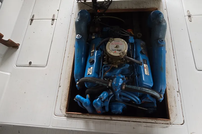 Slide: The Image of Engine compartment of a 1989 SportCraft 270 Fisherman boat with blue Crusader Marine engine. - 22