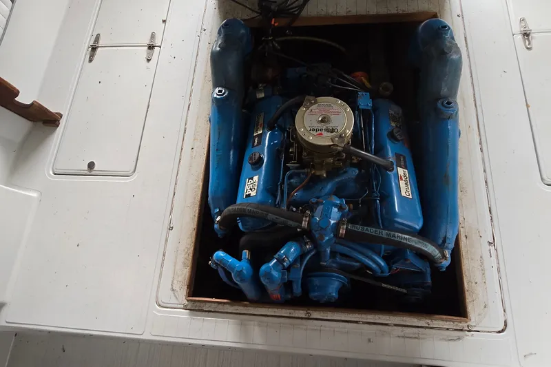 Slide: The Image of 1989 SportCraft 270 Fisherman boat engine, Crusader Marine, blue color, open compartment. - 21