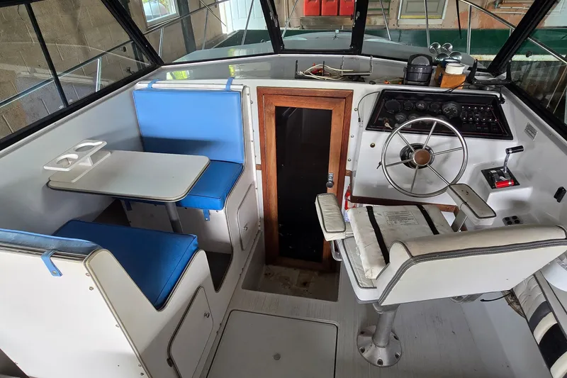 Slide: The Image of 1989 SportCraft 270 Fisherman boat interior with helm, seating, and table. - 10