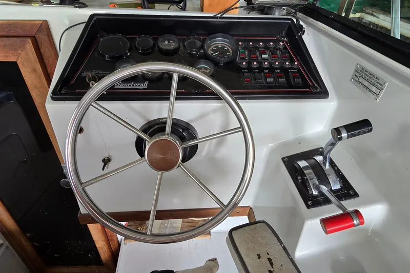 Slide: The Image of Steering console of a 1989 SportCraft 270 Fisherman boat with controls and gauges. - 14