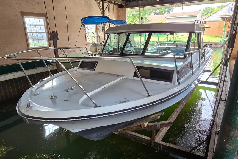 Slide: The Image of 1989 SportCraft 270 Fisherman boat in a covered dock, showcasing sleek design and sturdy build. - 3