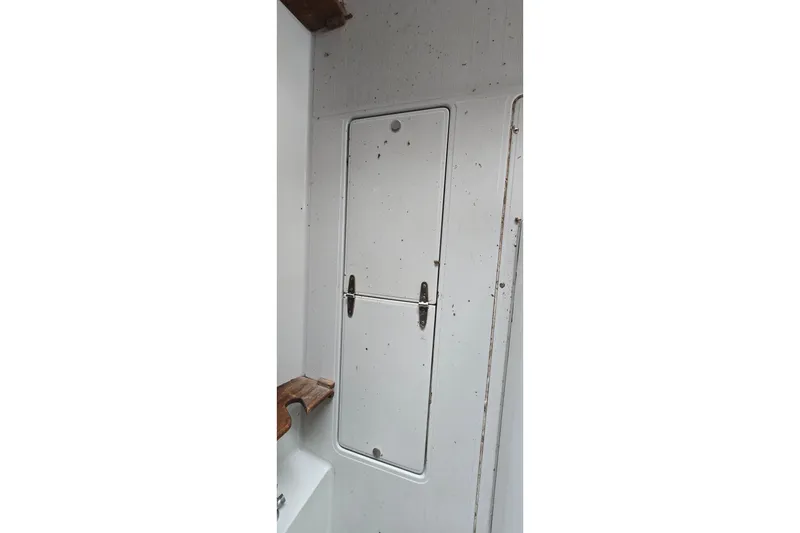 Slide: The Image of 1989 SportCraft 270 Fisherman cabin interior with white door and wooden accents. - 20