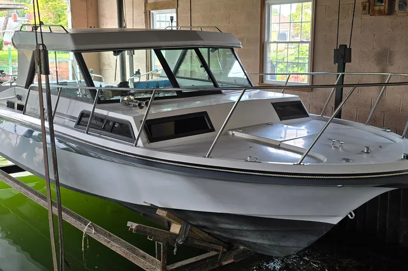 The Image of 1989 SportCraft 270 Fisherman boat in a boathouse, showcasing sleek design and sturdy build. - 1