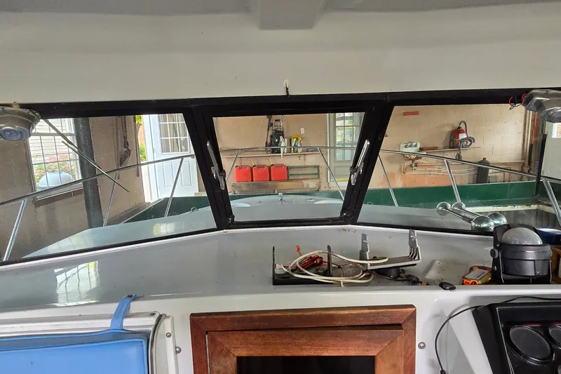 Slide: The Image of Interior view of a 1989 SportCraft 270 Fisherman boat in a garage. - 15