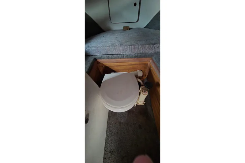 Slide: The Image of 1989 SportCraft 270 Fisherman boat interior with compact marine toilet. - 16