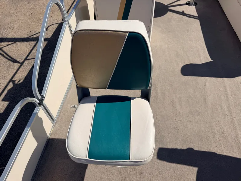 Slide: The Image of A cushioned boat seat with blue and beige pattern on a deck. - 15