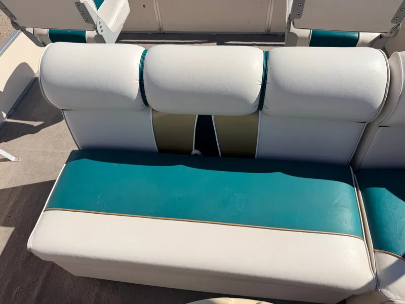 Slide: The Image of A white and turquoise seat on a boat, featuring padded backrests and gold accents. - 28
