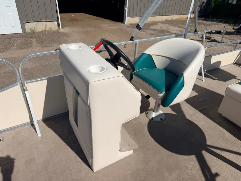 Slide: The Image of A helm station with a white and green seat on a boat. - 19