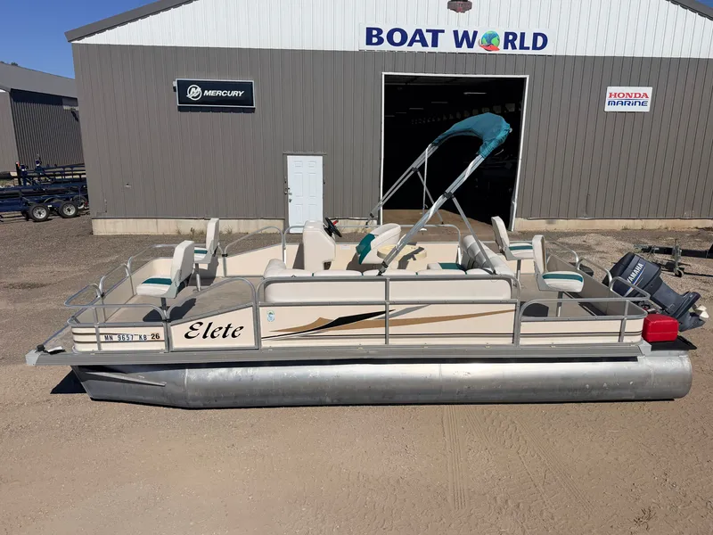Slide: The Image of A 2006 Elete pontoon boat with a 50HP Yamaha engine is parked outside a boat dealership. - 4