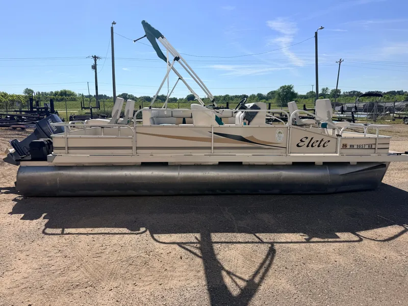 Slide: The Image of A 2006 Elete pontoon boat with a 50HP Yamaha engine, parked on dry land. - 18