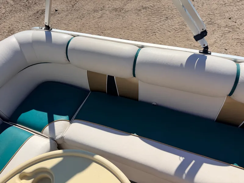 Slide: The Image of The image shows a boat seat with white and teal upholstery. - 25
