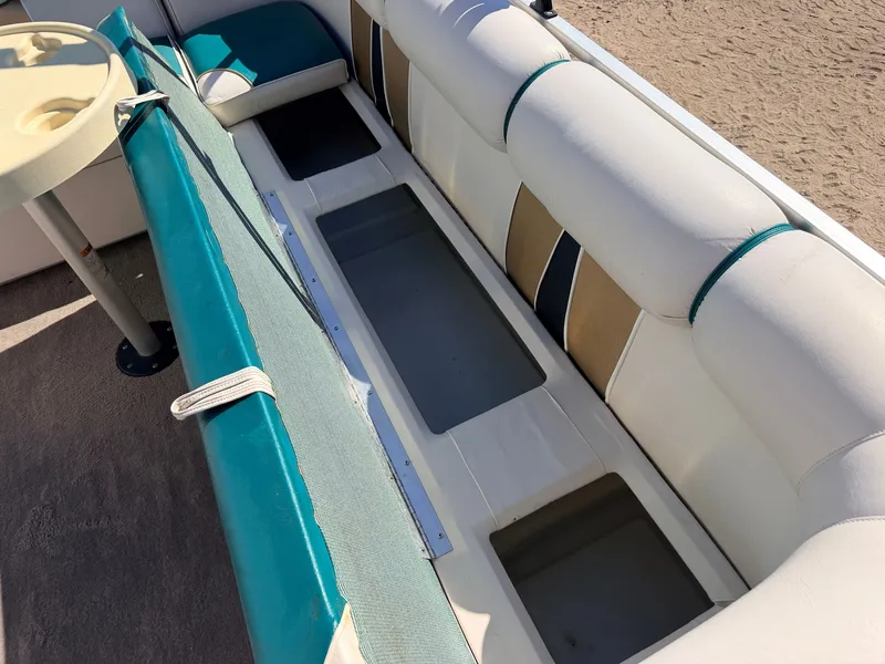 Slide: The Image of The image shows a boat's seating area with storage underneath and a cup holder. - 26