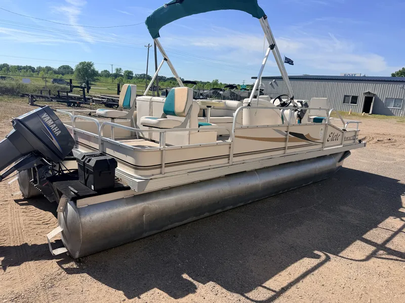 Slide: The Image of A pontoon boat with a 50HP Yamaha engine, featuring seating and a sunshade. - 49