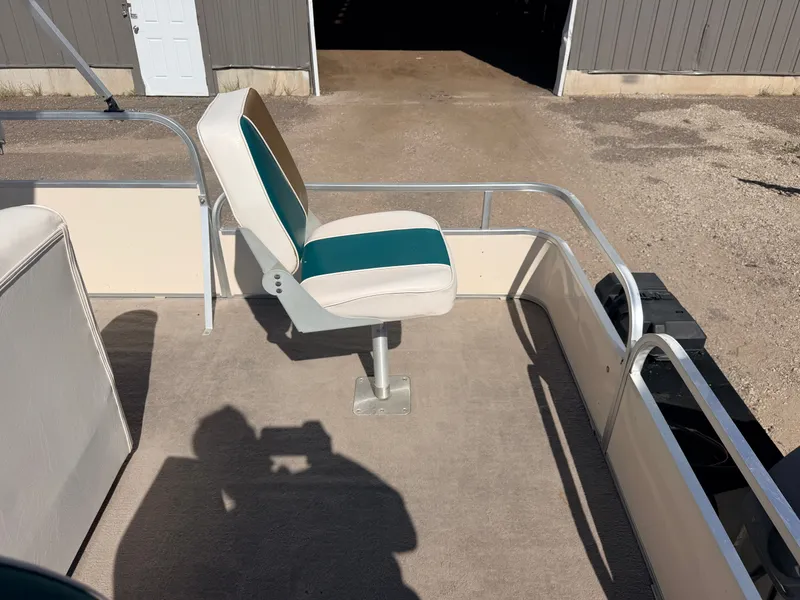 Slide: The Image of A boat with a cushioned seat on a carpeted floor. Buildings are visible in the background. - 36