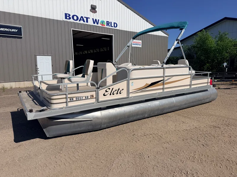 Slide: The Image of A pontoon boat named "Elete" is parked in front of a building. It features seating and a sunshade. - 41