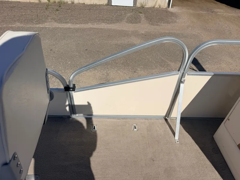 Slide: The Image of A boat with carpeted flooring and metal railing, situated on a dry, paved area. - 16