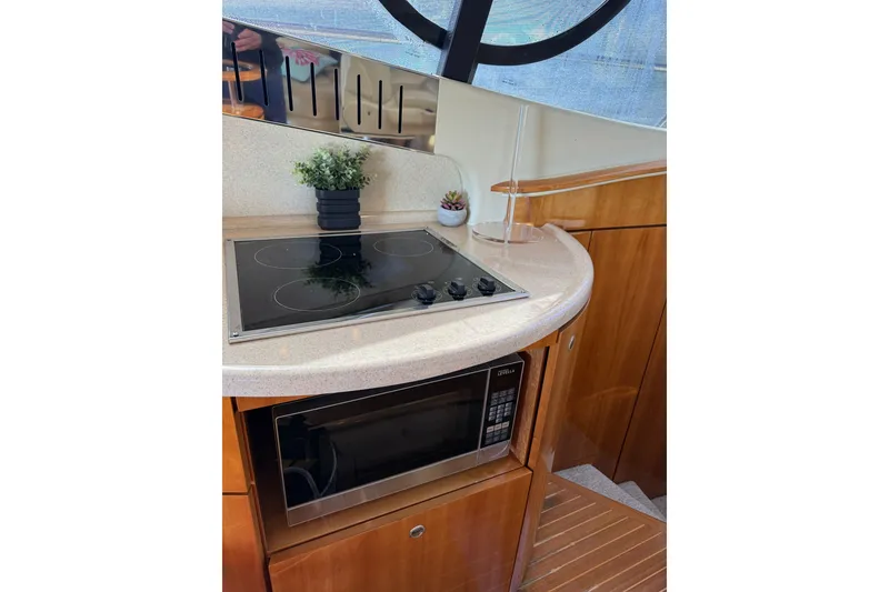Slide: The Image of Modern kitchen area on a 2008 Azimut 55E yacht with stove and microwave. - 18