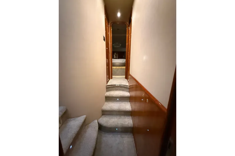 Slide: The Image of Interior hallway of 2008 Azimut 55E yacht with carpeted stairs and wooden accents. - 24