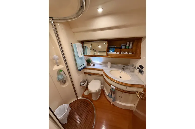 Slide: The Image of Luxurious 2008 Azimut 55E yacht bathroom with elegant wood accents and modern amenities. - 29
