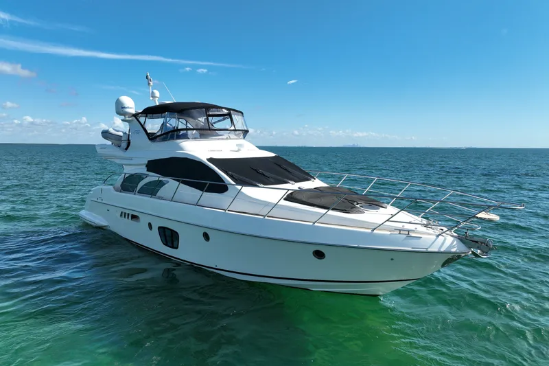 The Image of Luxurious 2008 Azimut 55E yacht cruising on clear blue ocean waters. - 0