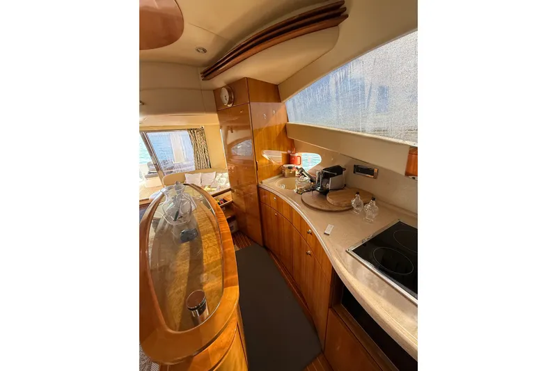 Slide: The Image of Luxurious interior of a 2008 Azimut 55E yacht, featuring a modern kitchen area. - 15