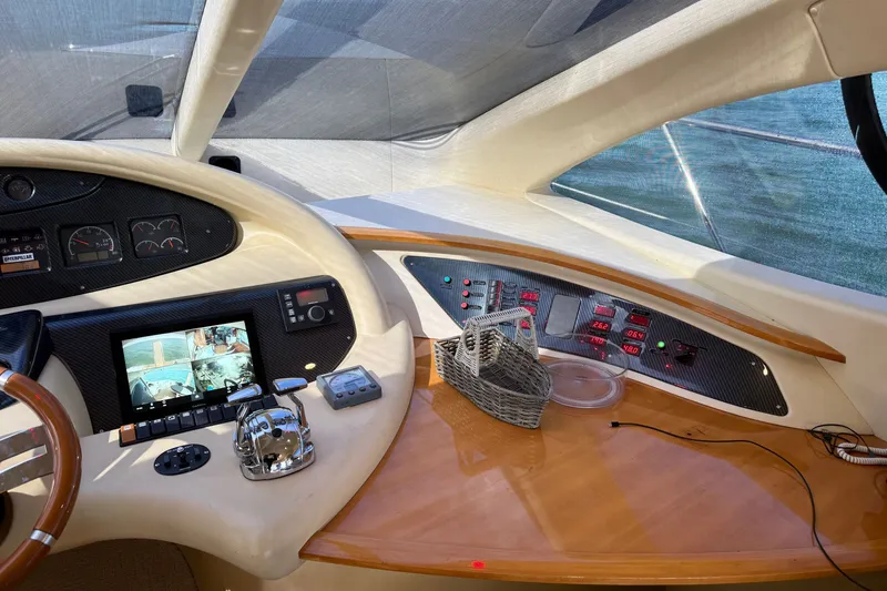 Slide: The Image of 2008 Azimut 55E yacht cockpit with navigation controls and display screens. - 17