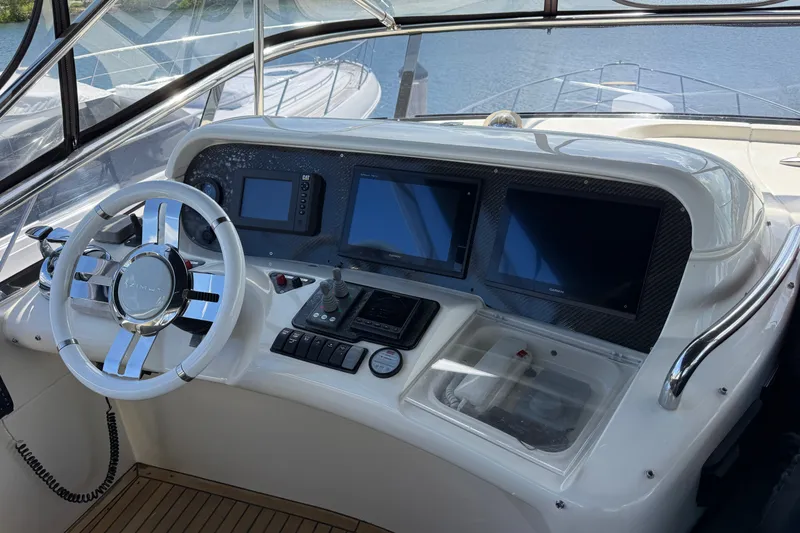 Slide: The Image of Cockpit of 2008 Azimut 55E yacht with modern navigation controls and steering wheel. - 31