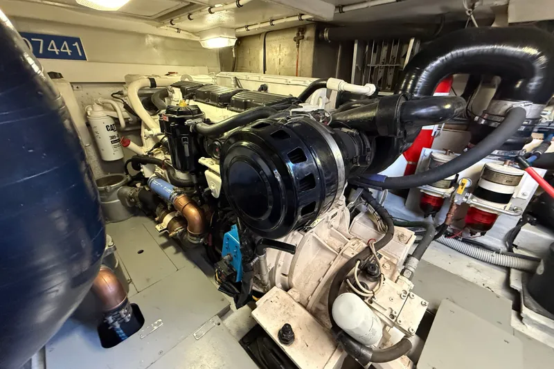 Slide: The Image of Engine room of a 2008 Azimut 55E yacht, showcasing mechanical components and piping. - 38