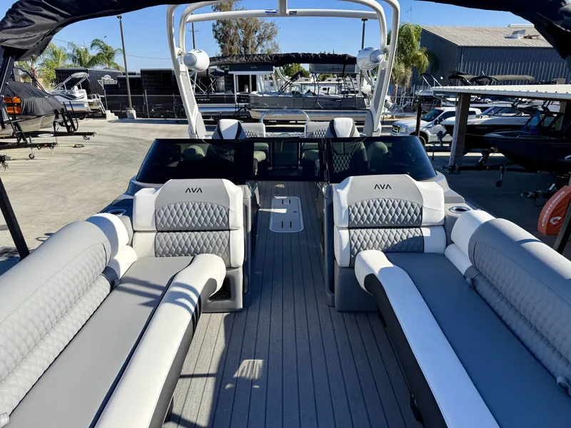 Slide: The Image of The image shows the interior of an Avalon Excalibur 27' LTD Quad Lounge with luxurious seating and modern design. - 4