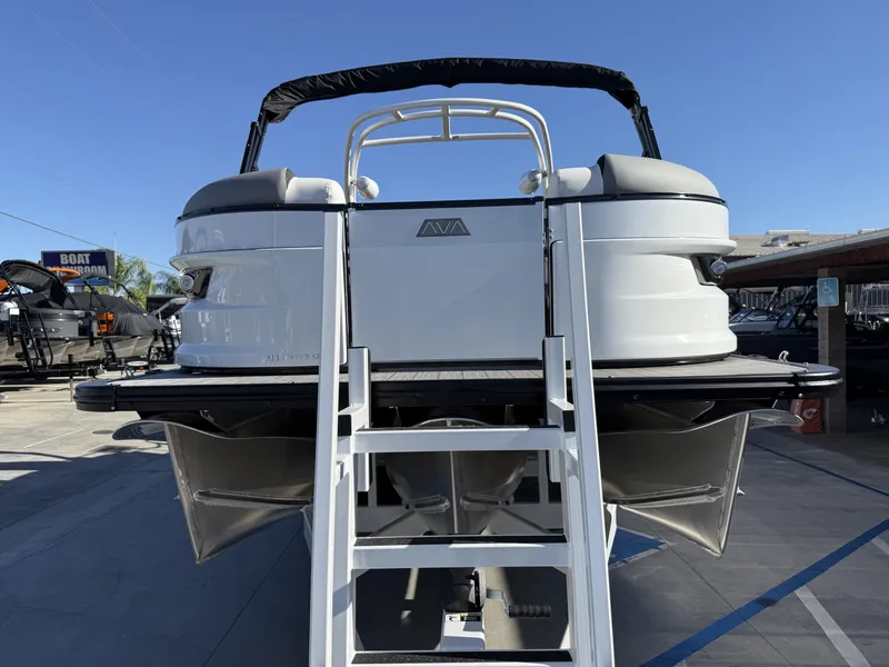 Slide: The Image of The image shows the rear of an Avalon Excalibur 27' LTD Quad Lounge with a ladder. It has a modern design. - 3