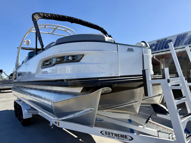 Slide: The Image of A luxurious Avalon Excalibur pontoon boat with sleek design and powerful engine on a trailer. - 2
