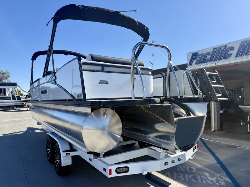 Slide: The Image of A luxurious pontoon boat with sleek design, equipped with a powerful engine, sits on a trailer. - 4