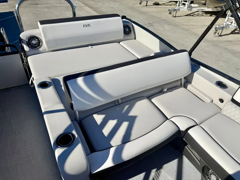 Slide: The Image of Luxurious white seating lounge on an Avalon boat, featuring cup holders and sleek details. - 10