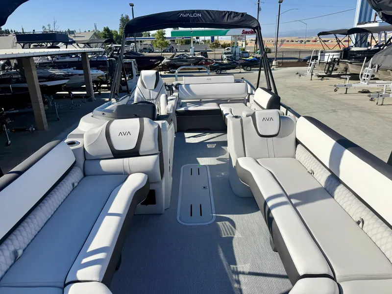 Slide: The Image of The image shows the interior of an Avalon 25' Catalina Platinum Versatile Rear Lounge boat. It features luxurious, cushioned seating and a modern design. - 6