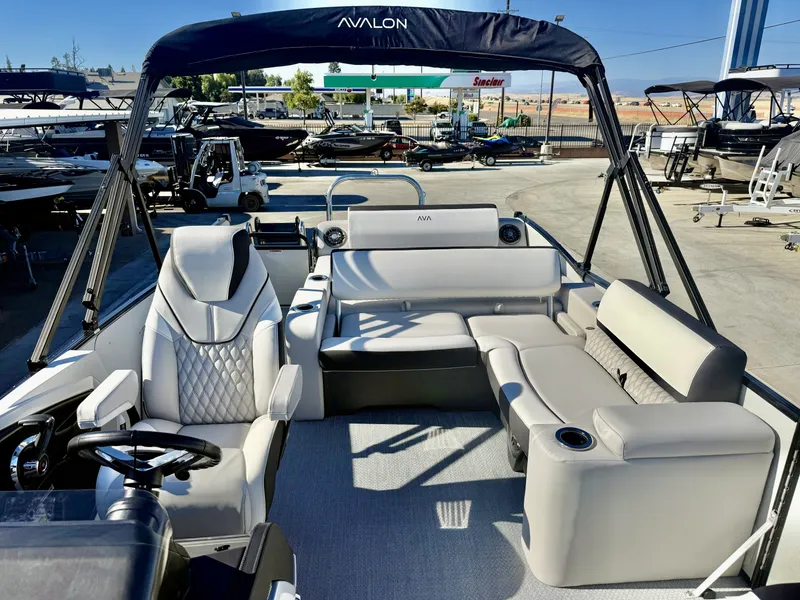 Slide: The Image of The image shows the interior of an Avalon 25' Catalina Platinum with luxurious seating and a helm. - 8