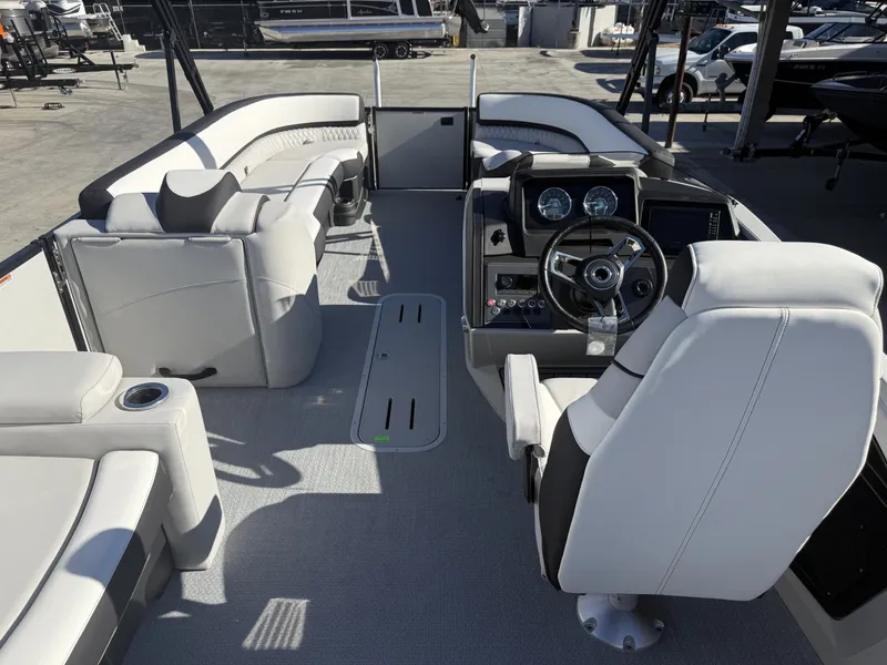 Slide: The Image of The image shows the interior of an Avalon 25' Catalina Platinum with a sleek helm and luxurious seating. - 13