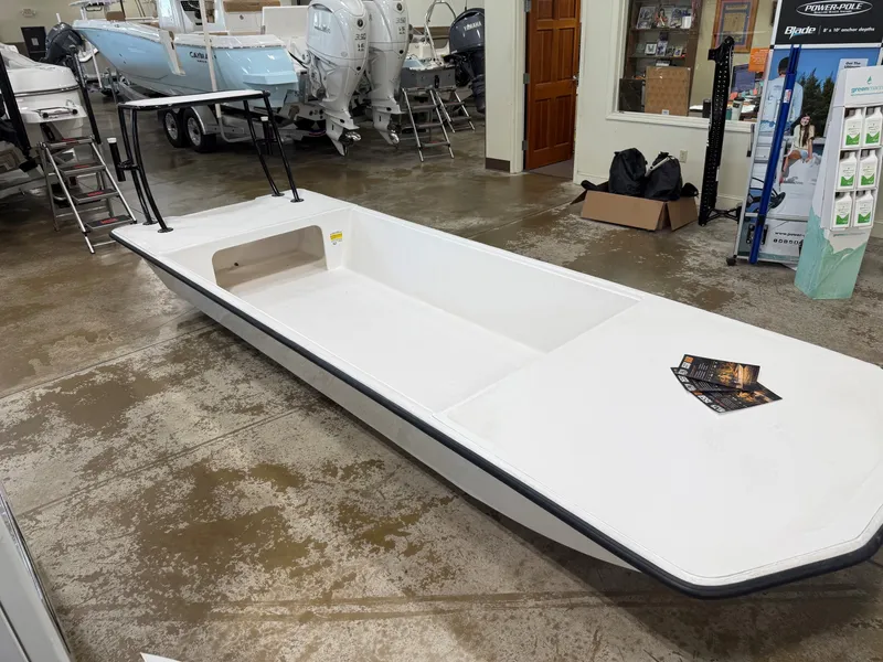 Slide: The Image of A 2027 Delta 1550 boat in a showroom. It features a simple, open design. - 3